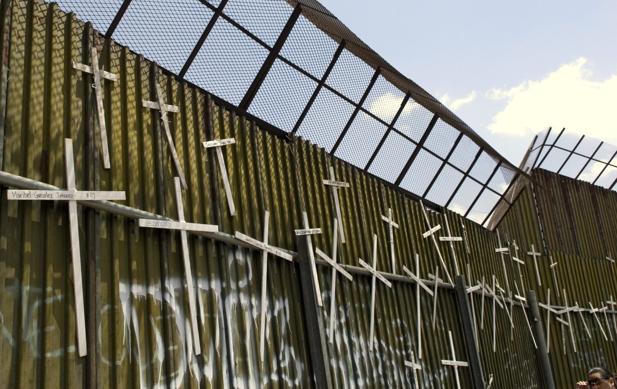 Crosses hang on the Mexican side of the border wall in Nogales, Mexico, commemorating the 4,000 people who have lost their lives attempting to cross the desert in search of a better life in the United States.